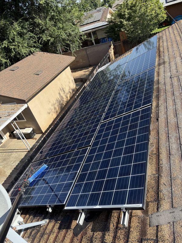 Freshly cleaned solar panels gleaming after an RO/DI purified-water wash