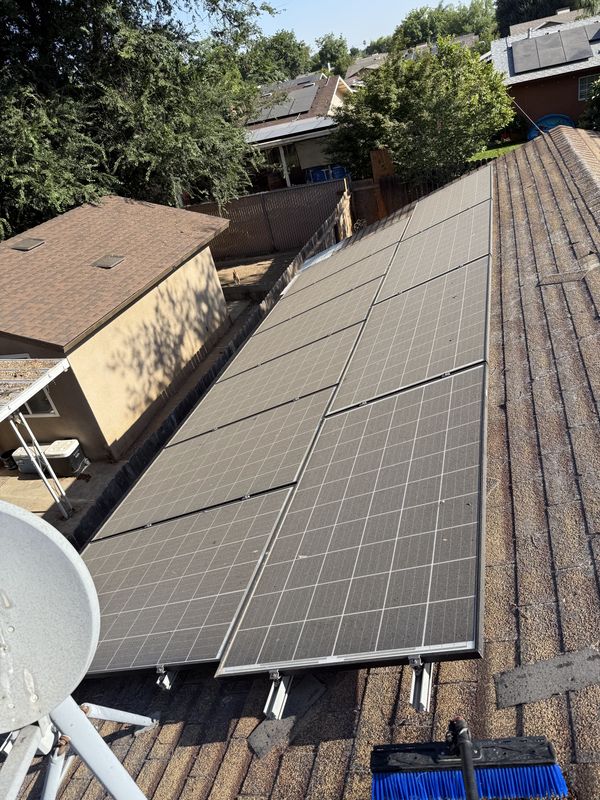 Solar panels dulled by a heavy layer of Central Valley dust before cleaning