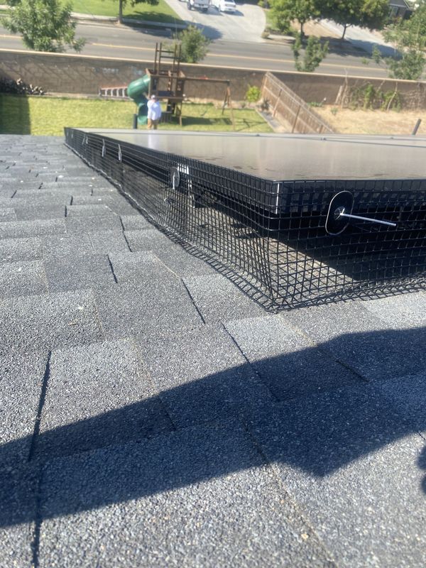 Bird-proofing mesh fastened with clips around a residential solar array