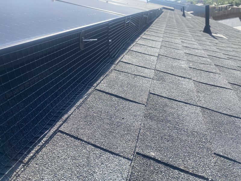 Bird-proofing mesh running the full length of a rooftop solar array